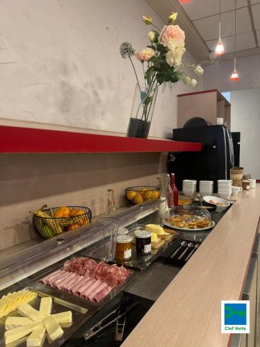 a buffet line with many different types of food at Kyriad Rennes Sud - Cesson Chantepie in Chantepie
