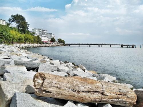 a pier over a body of water with rocks at Fürstenhof Sassnitz - PANORAMA103 in Sassnitz