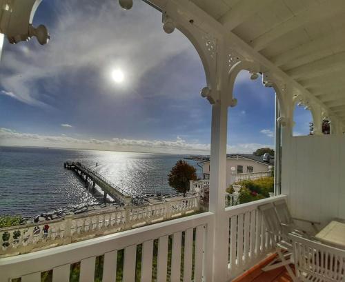 a balcony with a view of the ocean and a pier at Fürstenhof Sassnitz - PANORAMA103 in Sassnitz