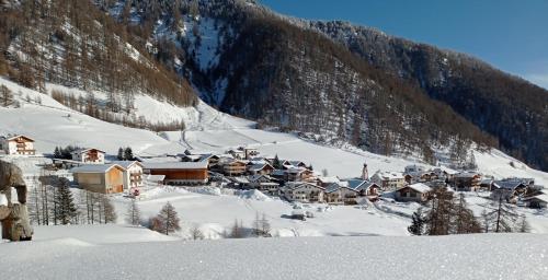 a small town in a snow covered mountain at Zangerlehof in Slingia