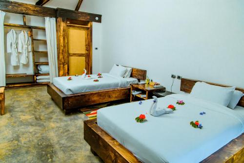 a room with two beds with flowers on them at Kuriftu Resort & Spa Bishoftu in Debre Zeyit