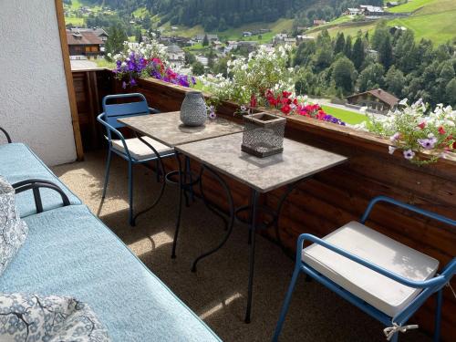 a table and chairs on a balcony with a view at Chalet 1480 in Gaschurn