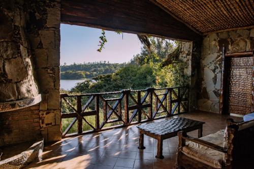 a porch with a bench and a view of a river at Kuriftu Resort & Spa Bishoftu in Debre Zeyit
