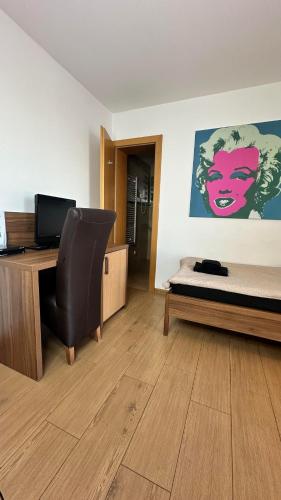 a bedroom with a bed and a desk and a chair at Hotel Muza in Košice