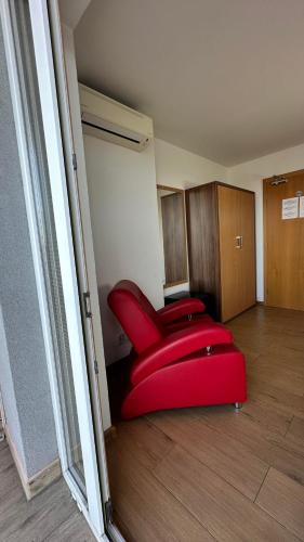 a room with two red chairs in a room at Hotel Muza in Košice