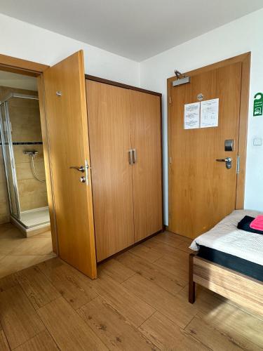 a bedroom with a closet and a bed and a door at Hotel Muza in Košice