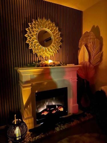 a mirror over a fireplace with a fire place at The Airport Homestay House in Christchurch