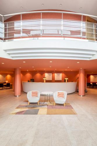 a large lobby with two chairs and a table at Acta Sant Just in Sant Just Desvern