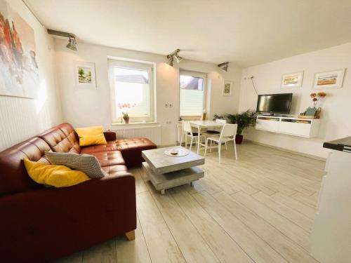 a living room with a leather couch and a table at Ferienhaus "Christin" Objekt-ID 15689-2 in Waren