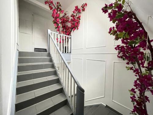 a stairway with purple flowers on the wall at Leimen51 WG3 in Leimen