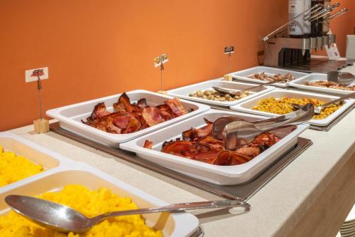 a buffet with several trays of food on a table at Acta Sant Just in Sant Just Desvern