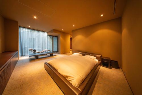 a bedroom with a large bed and a window at Azabu Modern House The Tokyo Tower can be seen from the villa 500m2 in Tokyo
