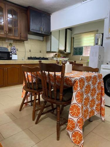 a kitchen with a table with two chairs and a table cloth at The Majestic Home Ampang in Kuala Lumpur