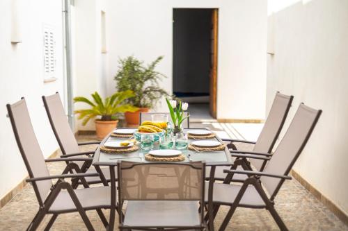 a dining room table with chairs and food on it at Albercutx Pollentia 1 2 3 in Port de Pollensa