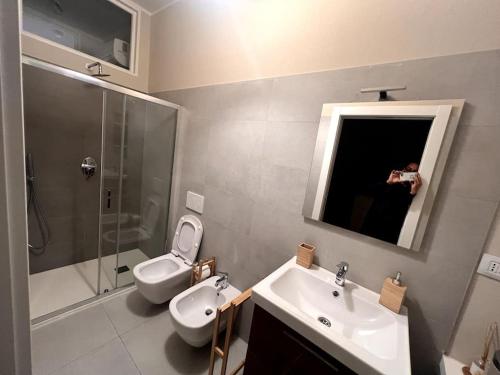 a person taking a picture of a bathroom at Bosazza 20 in Parma