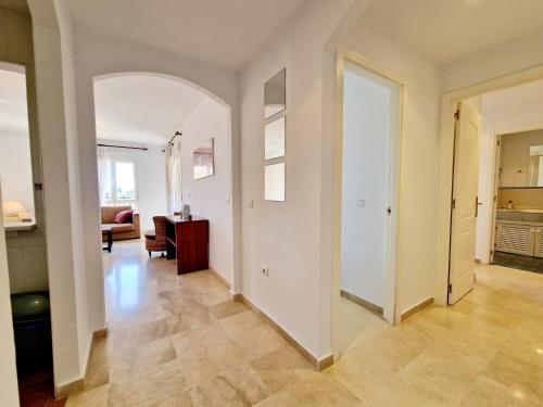 an empty living room with an archway and a hallway at Riviera Relax & Pool in Mijas Costa