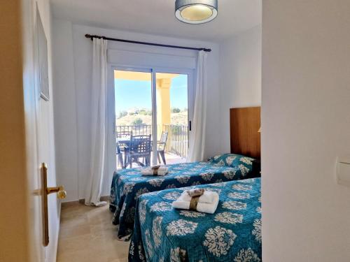 a hotel room with two beds and a balcony at Riviera Relax & Pool in Mijas Costa