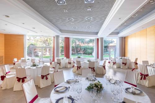 a banquet hall with white tables and chairs at Acta Sant Just in Sant Just Desvern