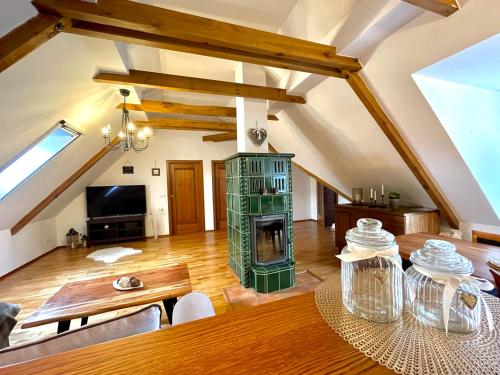 a living room with a wooden table and a fireplace at Historický dům u lázní in Třeboň