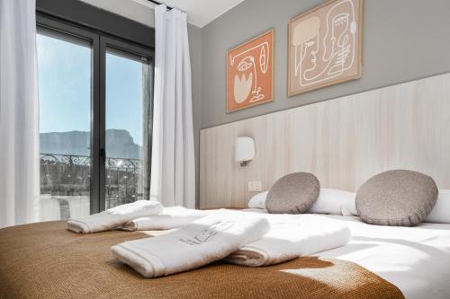 a bedroom with a bed with two pillows on it at Apartamentos Torre del Reloj in Jaca