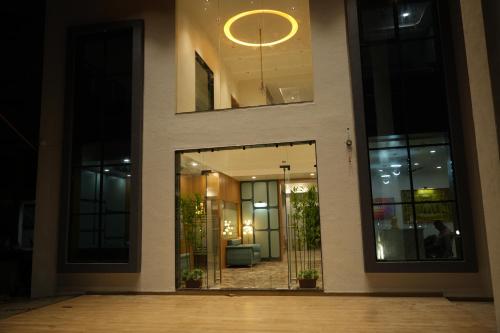 a lobby of a building with a large glass door at Hotel Amrut Inn Hospitalities in Somnath