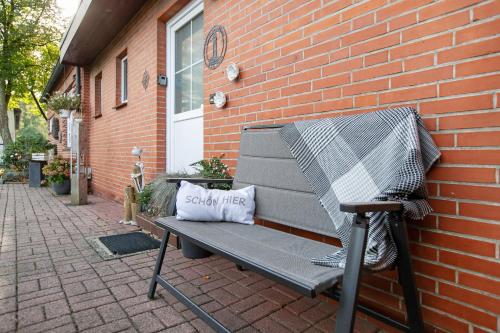 a bench next to a brick building with a pillow on it at Kompass Oase in Burg