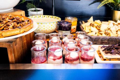 a buffet filled with different types of food and desserts at Campanile Roissy - Aéroport CDG - Le Mesnil Amelot in Le Mesnil-Amelot