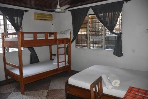 een kamer met 2 stapelbedden en 2 ramen bij Kituri Hostel in Dar es Salaam