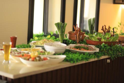 a buffet with bowls of food on a table at Alqalah Restotel فندق ومطعم القلعة in Kerak