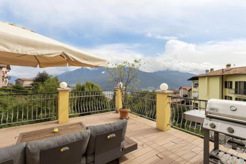 a balcony with a grill and a table and chairs at Magic Terrace With Lake View in Stazzona
