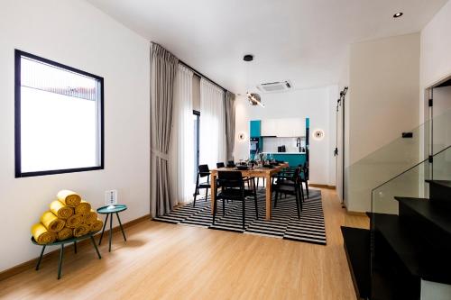 a dining room and living room with a table and chairs at 5BR Modern Luxury Pool Villa Patong TPSV140 in Patong Beach