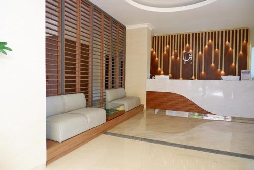 a living room with a couch and a table at Point C Hotel in Bandung