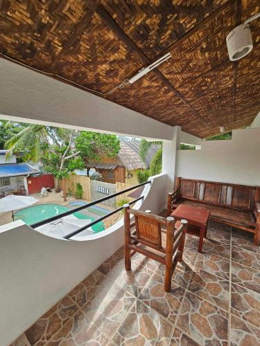 a living room with a couch and a boat at Acacia Sunset Village Inn in Dauis