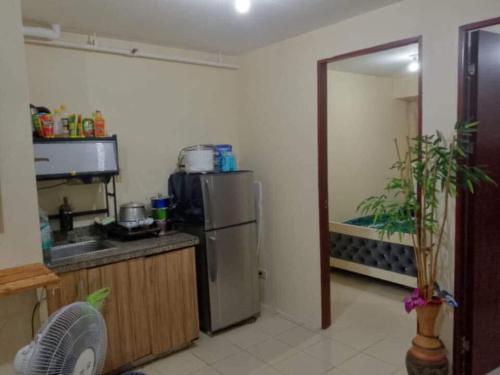 a kitchen with a sink and a refrigerator at 888 accommodation in Manila