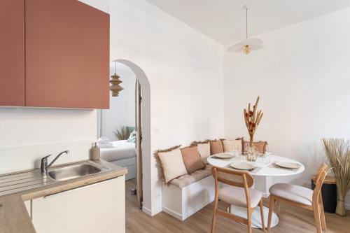 une cuisine et un salon avec une table et un canapé dans l'établissement Terra Rosa - Apt à 5min de la plage, à Dinard