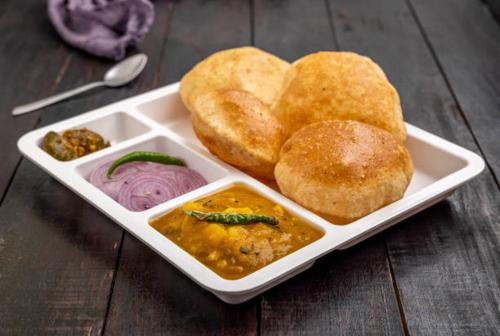 a white tray of food with bread and dips at Hotel Singh International, Amritsar in Amritsar