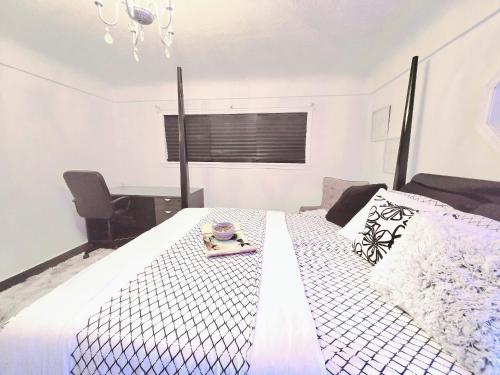a bedroom with a bed with a tray of food on it at Private Cozy and Spacious 2br Home with TeePee Dining Room! Private Parking! Self Check-in in Burnaby