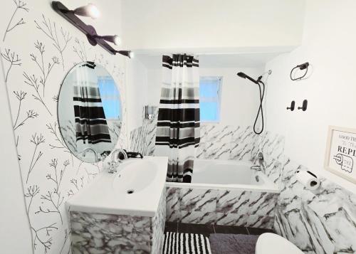 a bathroom with a sink and a mirror at Private Cozy and Spacious 2br Home with TeePee Dining Room! Private Parking! Self Check-in in Burnaby