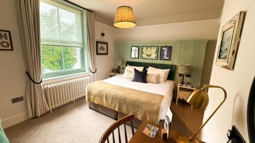 a bedroom with a bed and a window at Mill on the Exe in Exeter