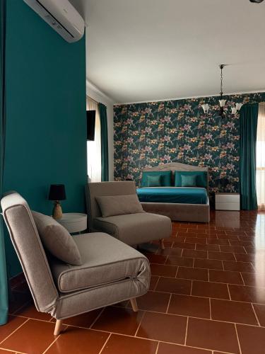 a living room with a couch and a chair at Palm House in Lamezia Terme