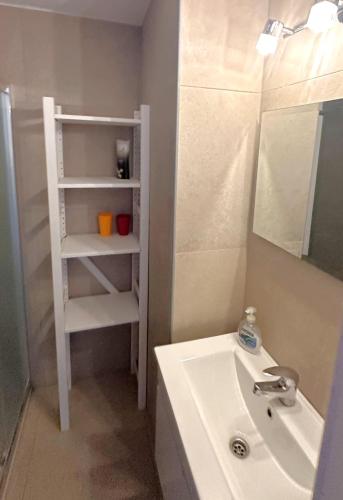 a white bathroom with a sink and a mirror at Seafront Escape in Latchi in Polis Chrysochous