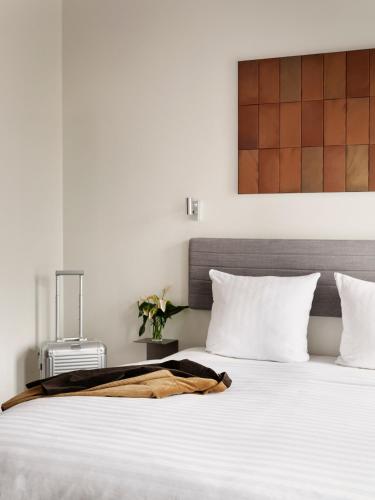 a bedroom with a bed with a blanket on it at Mekano Apartment Hotel in Copenhagen
