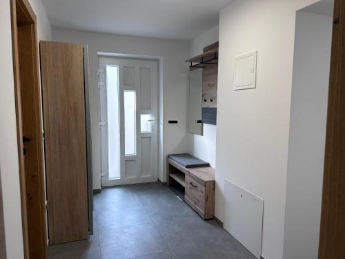 a room with a hallway with a door and a kitchen at Apartment Angelina in Cerklje na Gorenjskem