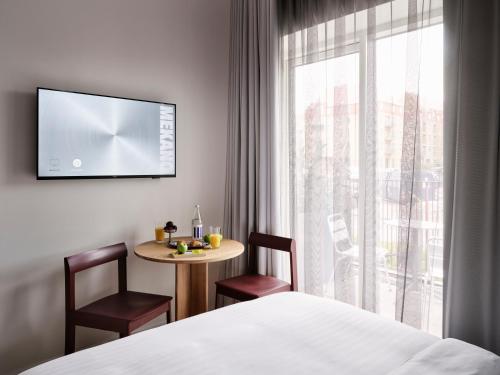 a hotel room with a bed and a table and a window at Mekano Apartment Hotel in Copenhagen