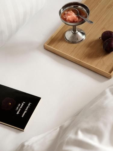 a wooden tray with a bowl of food on a table at Mekano Apartment Hotel in Copenhagen