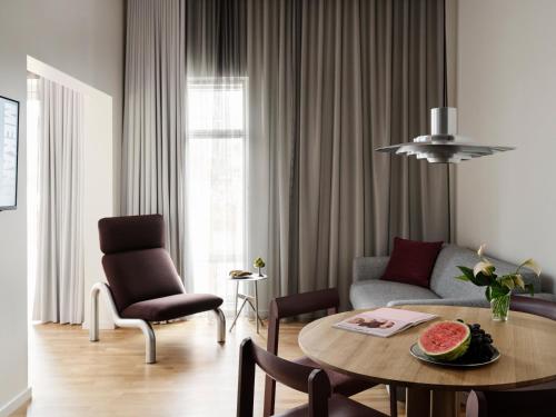 a living room with a couch and a table at Mekano Apartment Hotel in Copenhagen