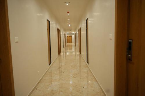 a hallway of a building with a long corridor at Hotel Amrut Inn Hospitalities in Somnath