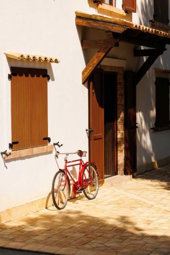 a red bike parked next to a building at La Terrazza sul Mare in Eraclea Minoa