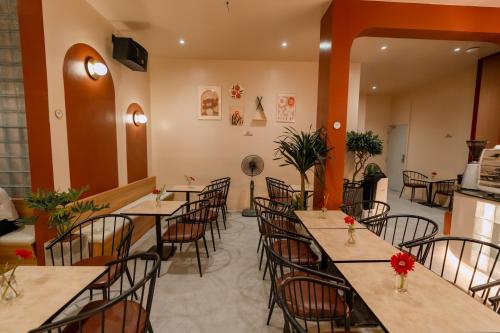 a row of tables and chairs in a restaurant at Gaki Hotel in Hue
