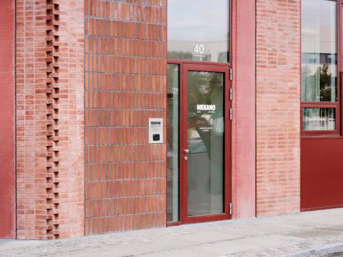 an entrance to a brick building with a red door at Mekano Apartment Hotel in Copenhagen